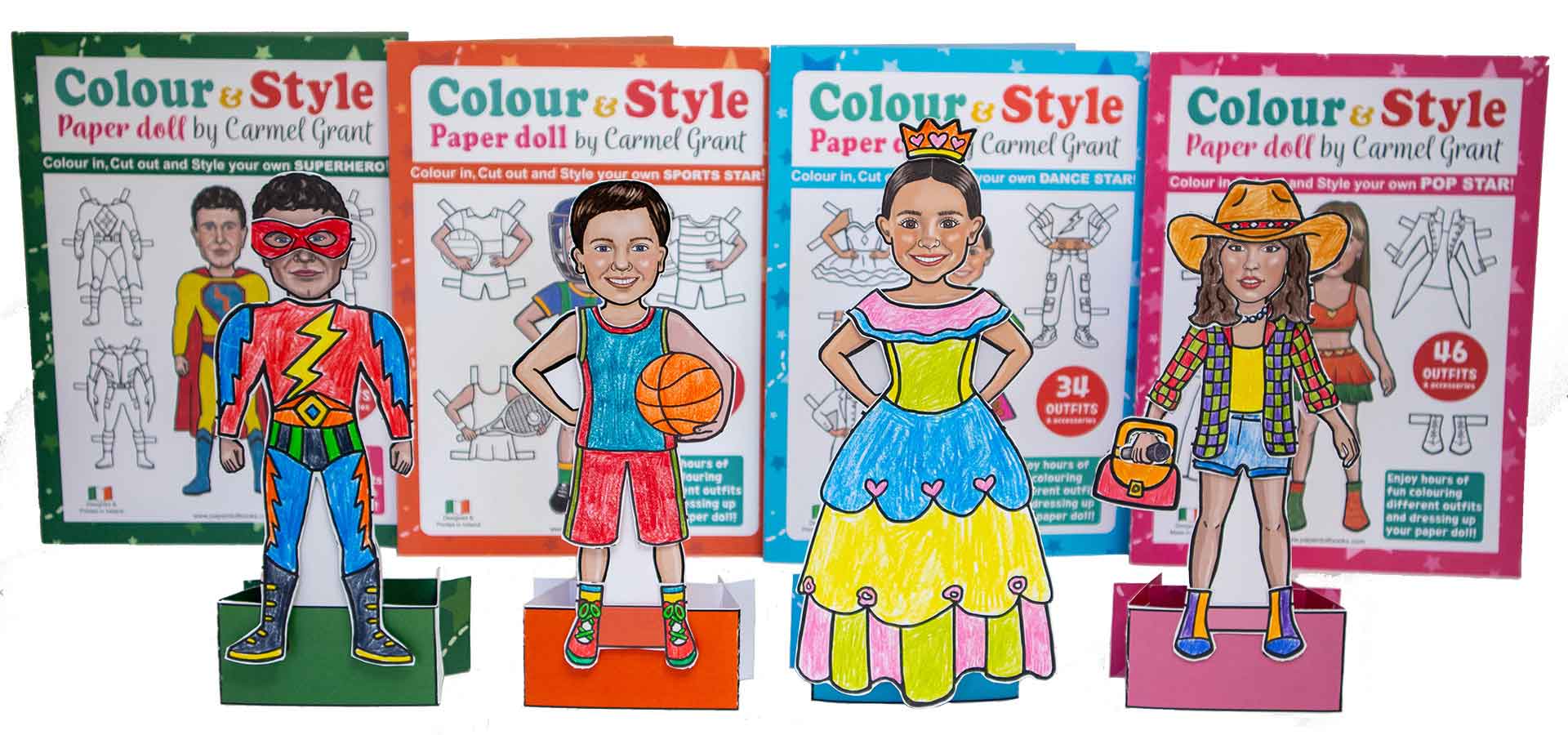 Four colorful paper doll cut out books with matching paper doll cutouts displayed in front, each featuring different character designs: a superhero, a boy in athletic wear, a princess, and a girl in a cowboy outfit. The boxes are branded 'Colour & Style Paper doll by Carmel Grant'.